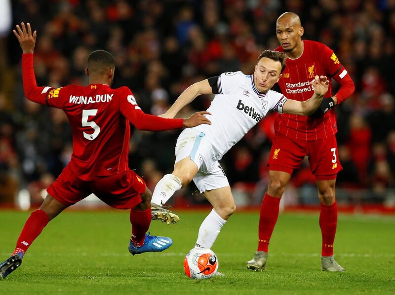 West Ham United's Mark Noble in action with Liverpool's Georginio Wijnaldum and Fabinho. Reuters