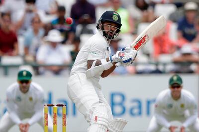 Indian batsman Shikhar Dhawan avoids a bouncer during the fourth day of the first Test cricket match between South Africa and India at Newlands cricket ground on January 8, 2018 in Cape Town, South Africa.   / AFP PHOTO / GIANLUIGI GUERCIA