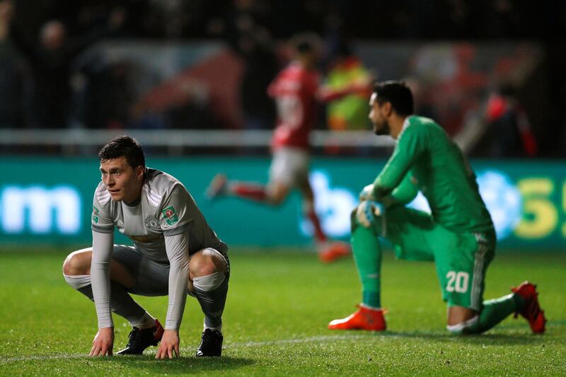 Manchester United’s Victor Lindelof and Sergio Romero after Bristol City's Korey Smith scores the winning goal. John Sibley / Reuters