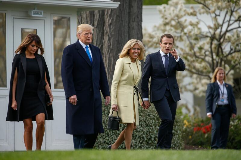 US President Donald Trump (2-L) and First Lady Melania Trump (L) walk with French President Emmanuel Macron (R) and his wife Brigitte Macron (2-R) walk from the Oval Office to a tree planting ceremony on the South Lawn of the White House in Washington, DC, USA, on April 23, 2018. Shawn Thew / EPA