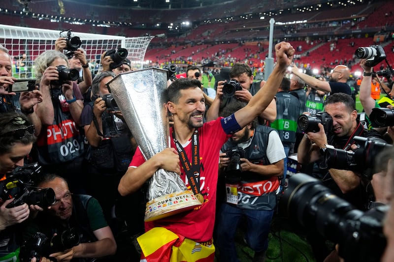 Sevilla's Jesus Navas carries the trophy after winning the Europa League final football match against Roma in Budapest. AP