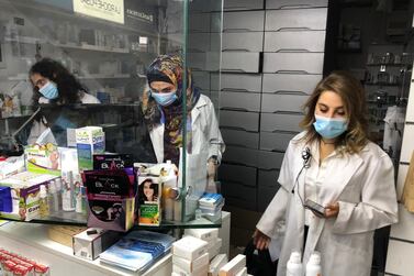 Pharmacist Siham Itani, right, inside her pharmacy in Beirut. Reuters