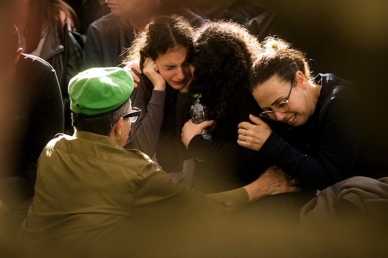 Family and friends mourn during a funeral for Maj Roy Meldasi in Afula, Israel. Getty Images