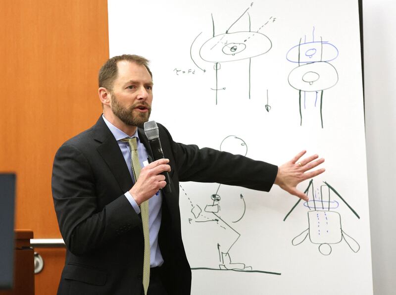 Biochemical engineer Irving Scher provides whiteboard sketches to explain why he thinks Paltrow's explanation of the crash is consistent with the laws of physics