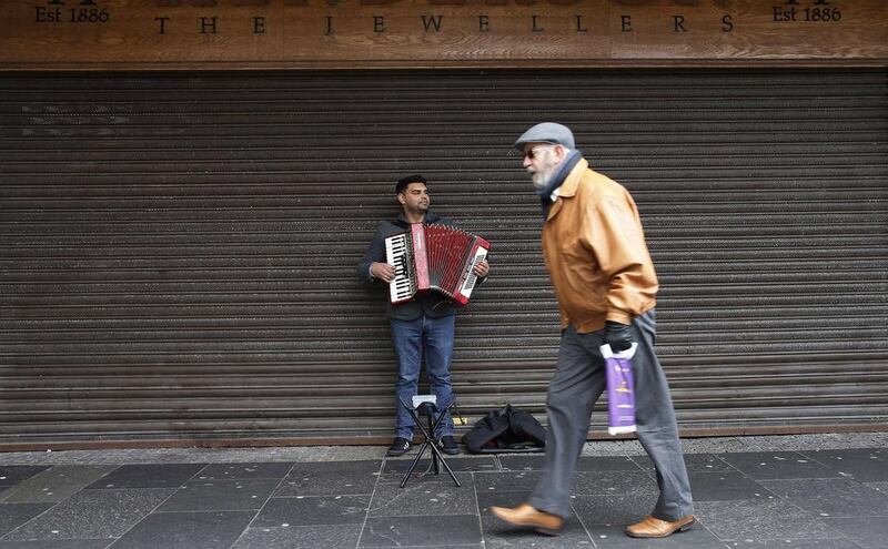 A busker plays the accordion on King Street, the main shopping street in Kilmarnock. Suzanne Plunkett / Reuters