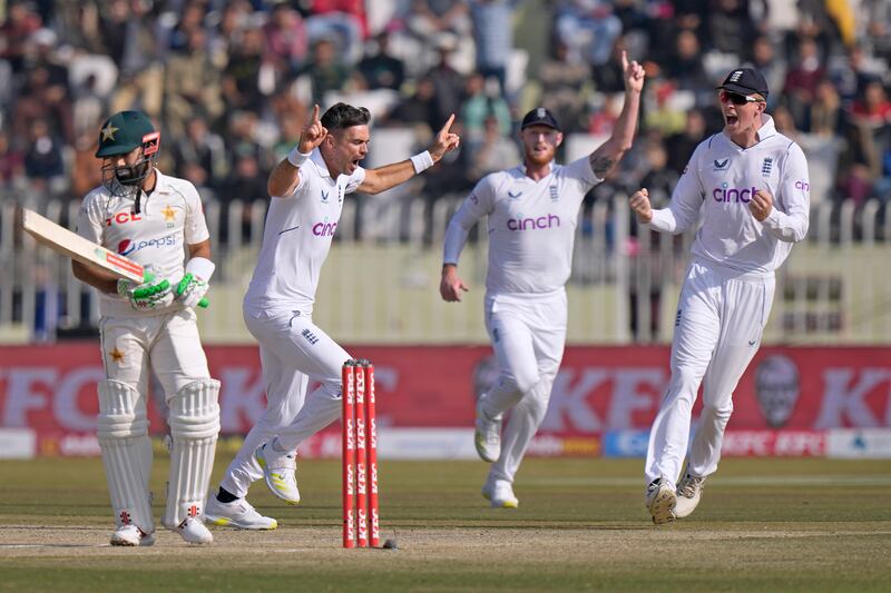 England's James Anderson celebrates with teammates after taking the wicket of Muhammad Rizwan. AP