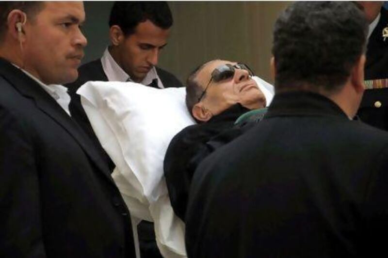 Former Egyptian president Hosni Mubarak arrives on a stretcher for a new hearing in Cairo last week. Prosecutors demanded that Mubarak be executed for alleged involvement in killing hundreds of protesters.