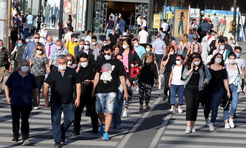 People wear protective face masks against curb the spread of the coronavirus in Kizilay Square, in Ankara, Turkey.  AFP