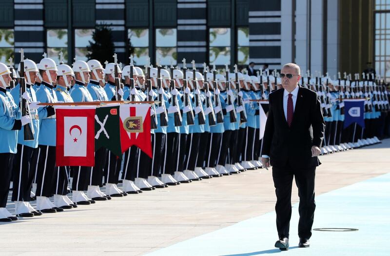 Turkey's President Recep Tayyip Erdogan, reviews an honour guard prior to a welcome ceremony for Ukraine's President Vladimir Zelenskiy, at the Presidential Palace in Ankara, Turkey, Wednesday, Aug. 7, 2019. Turkey's Defence Minister Hulusi Akar says his country would like to establish a safe zone in northeast Syria jointly with the United States but would act alone if necessary.(Presidential Press Service via AP, Pool)