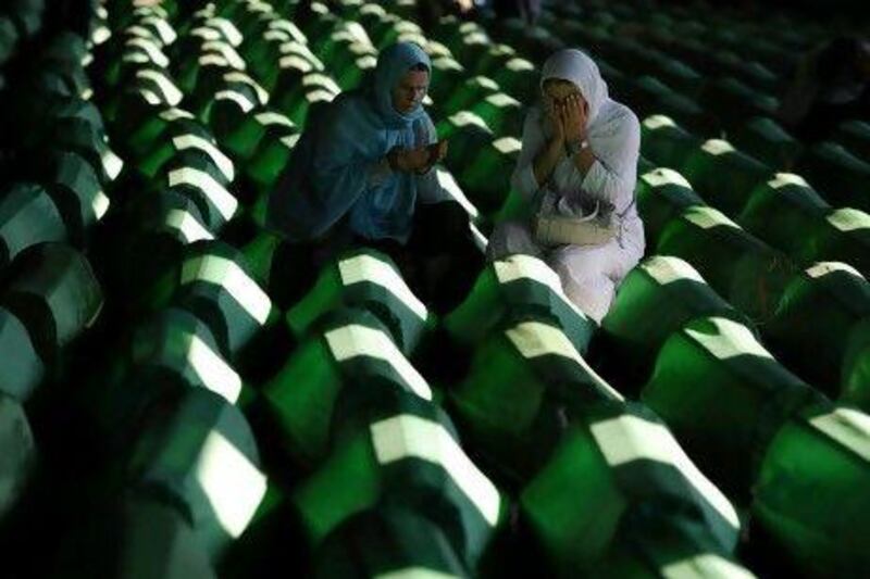 Bosnian Muslim women mourn at the Srebrenica Memorial Cemetary in 2011. In 1995, the UN-protected enclave fell to Bosnian Serb troops, where alleged war crimes took place.