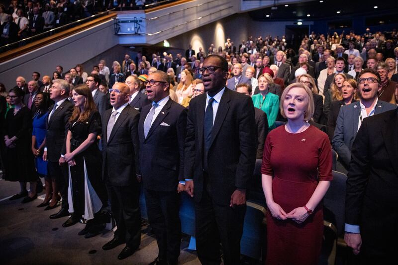 The prime minister and members of her Cabinet sing the national anthem at the opening session. EPA