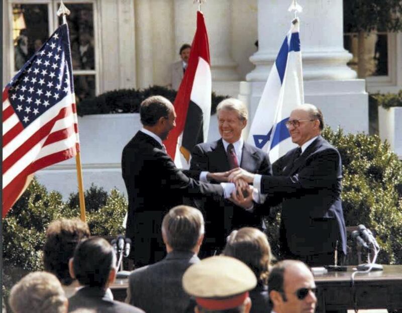 U.S. President Jimmy Carter, Egyptian President Anwar Sadat and Israeli Prime Minister Menachem Begin join hands in celebration of the signing of the ÒTreaty of Peace Between the Arab Republic of Egypt and the State of IsraelÓ at the White House in Washington, D.C., March 26, 1979.    Courtesy Jimmy Carter Library/National Archives/Handout via REUTERS    ATTENTION EDITORS - THIS IMAGE WAS PROVIDED BY A THIRD PARTY