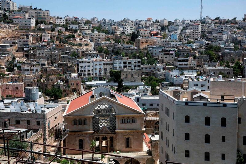Tthe Israeli settlement point of Beit Hadasa with Palestinian neighborhoods in the background, in the city of Hebron in the occupied West Bank.  AFP