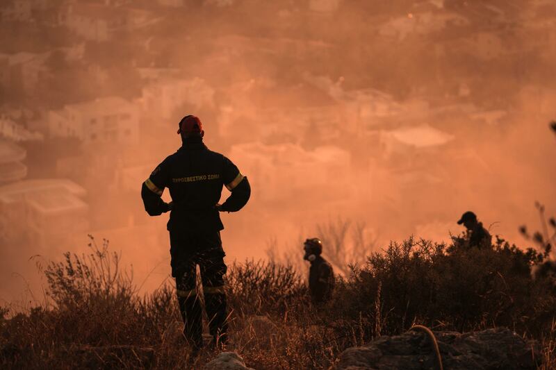 Firefighters attend a wildfire in Saronida, south of Athens, Greece, last week. Bloomberg