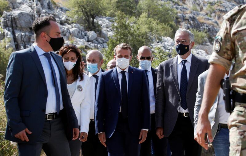 French President Emmanuel Macron speaks to victims of the blast as he arrives to a ceremony to plant a cedar next to members of the NGO Jouzour Loubnan in Jaj, near Beirut, Lebanon.  EPA
