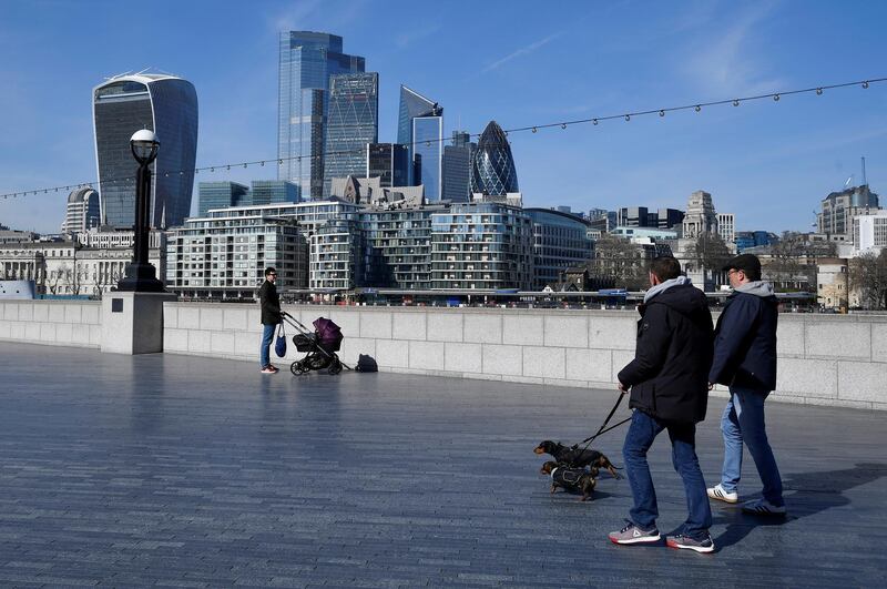 People walk their dogs in London. Reuters