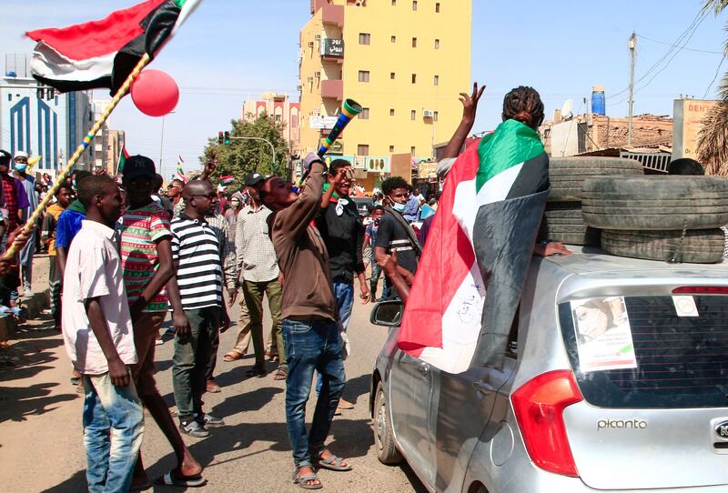 Sudanese demonstrators march in Khartoum. Roads leading to military headquarters and the presidential palace were reported to have been sealed off by government forces. AFP