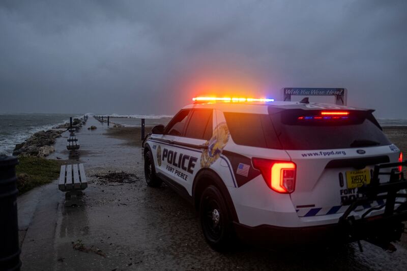 A police car blocks the entrance to the Inlet State Park before the expected arrival of Hurricane Nicole in Fort Pierce, Florida. Reuters