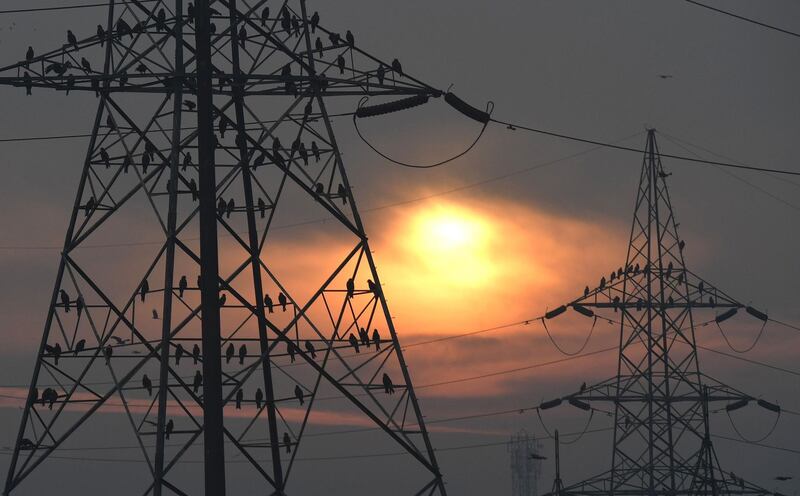 (FILES) In this file photo taken on February 17, 2017 birds sit on electricity pylons as the sun rises behind them on the outskirts of New Delhi.
Indus Towers and Bharti Infratel are merging to create the world's largest mobile tower operator, outside China, according to a statement from Bharti Airtel, Idea Cellular and Vodafone Group, with the new venture holding 163,000 towers across 22 telecom service areas, reported the Press Trust of India (PTI). / AFP PHOTO / Prakash SINGH