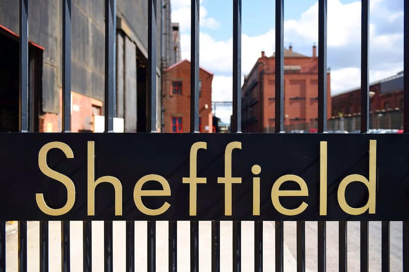 The word “Sheffield” sits in the entrance gates to a Sheffield steel mill. Oli Scarff / AFP