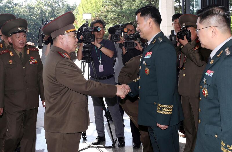 North Korean Lt. Gen. An Ik San, center left, shakes hands with his South Korean counterpart Maj. Gen. Kim Do-gyun upon his arrival at the Peace House at the border village of Panmunjom, South Korea. Korea Pool / Yonhap via AP