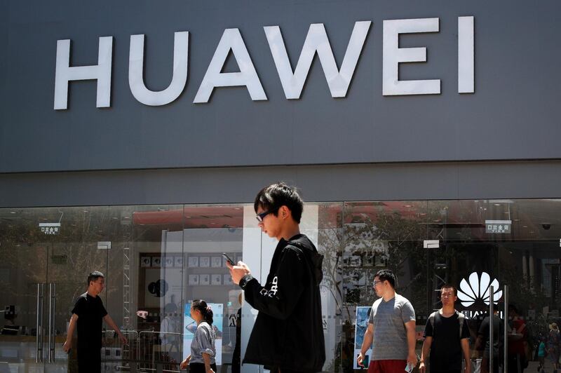 People walk past a Huawei retail store in Beijing, Sunday, June 30, 2019. Once again, Presidents Donald Trump and Xi Jinping have hit the reset button in trade talks between the world's two biggest economies, at least delaying an escalation in tension between the U.S. and China that had financial markets on edge and cast a cloud over the global economy. (AP Photo/Andy Wong)