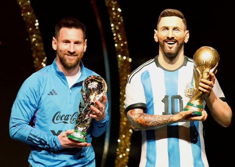 Argentina's Lionel Messi poses with a statue of himself at the Conmebol headquarters in Luque, Paraguay, on Monday, March 27, 2023, Reuters