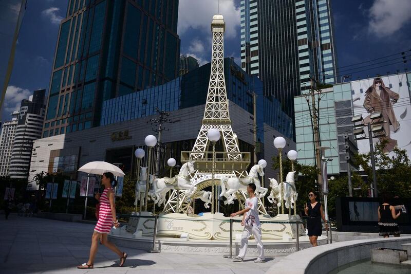 A merry-go-round modeled on Paris’ Eiffel Tower is seen outside an upmarket shopping mall in Shanghai. Peter Parks / AFP Photo