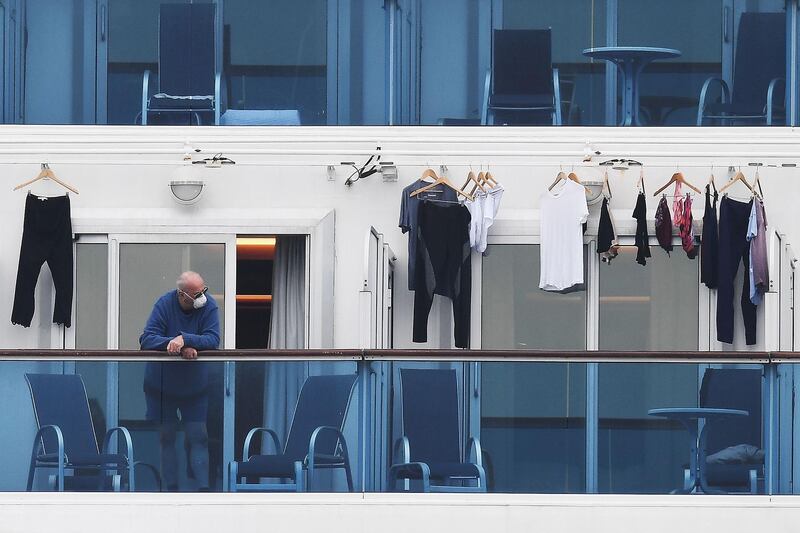 A passenger is seen on a balcony of the Diamond Princess cruise ship. AFP