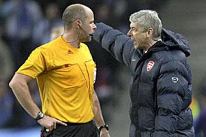 Wenger argues his case with Swedish referee Martin Hansson from the sidelines.