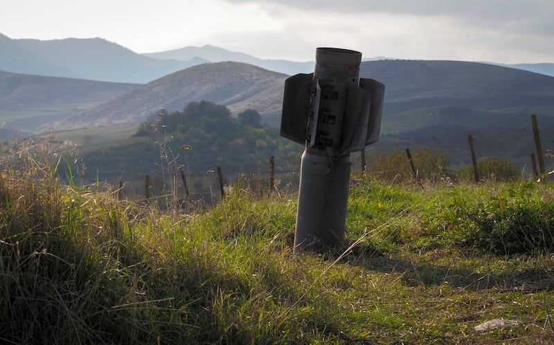 A tail of a multiple rocket 'Smerch' sticks out of the ground near the town of Martuni, the separatist region of Nagorno-Karabakh. AP