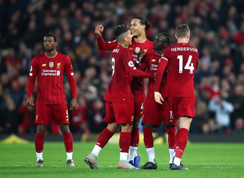 LIVERPOOL, ENGLAND - DECEMBER 29: Sadio Mane of Liverpool celebrates with Virgil van Dijk of Liverpool and Jordan Henderson of Liverpool after scoring his sides first goal during the Premier League match between Liverpool FC and Wolverhampton Wanderers at Anfield on December 29, 2019 in Liverpool, United Kingdom. (Photo by Clive Brunskill/Getty Images)