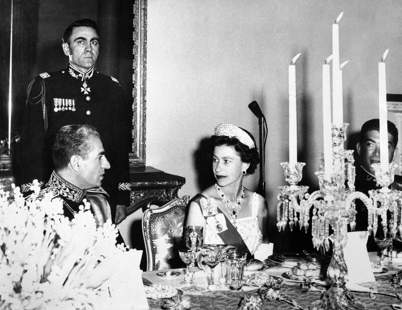 The queen with the Shah Mohammed Reza Pahlevi of Iran during a banquet in Tehran on March 2, 1961. AP