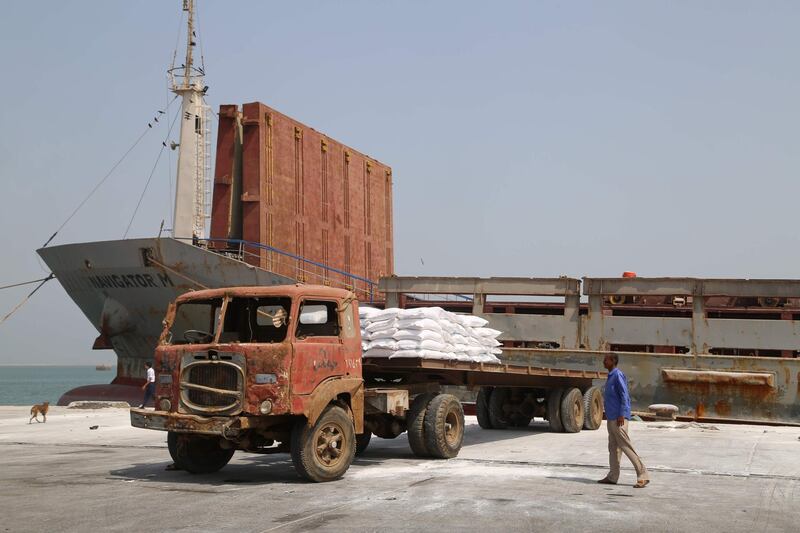 A Yemeni walks past a food aid shipment from the World Food Programme (WFP) in the Yemeni port city of Hodeida. The escalation of attacks by Iran-aligned Huthi rebels on Saudi cities threatens a hard-won UN-sponsored ceasefire deal for the Red Sea port city of Hodeida, war-ravaged Yemen's main conduit for humanitarian aid. / AFP / -
