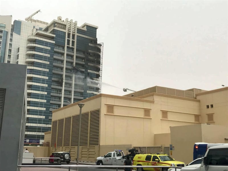 <p>Emergency services work to put out the fire at Zen Tower in Dubai Marina. 13 May 2018.&nbsp;Leslie Pableo for The National</p>
