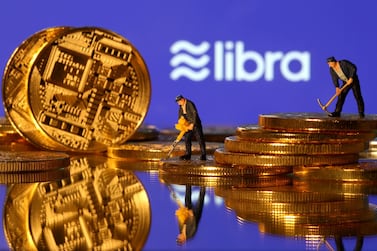 FILE PHOTO: Small toy figures are seen on representations of virtual currency in front of the Libra logo in this illustration picture, June 21, 2019. REUTERS/Dado Ruvic/File Photo