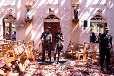 Sri Lankan soldiers look on inside the St Sebastian's Church at Katuwapitiya in Negombo on April 21, 2019, following a bomb blast during the Easter service. AFP / STR