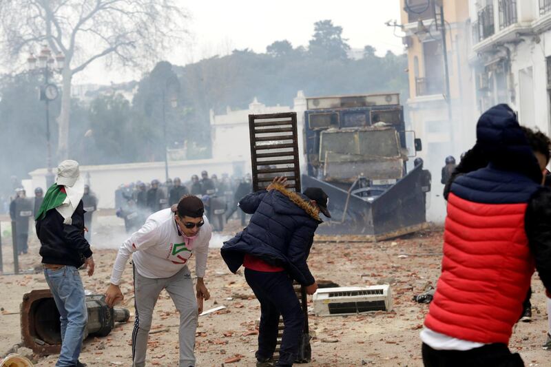 People clash with anti-riot police during the protest against President Abdelaziz Bouteflika, in Algiers, Algeria. Reuters