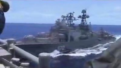 In this image from video provided by the U.S. Navy, a Russian destroyer, left, sails very close to the USS Chancellorsville, right, while operating in the Philippine Sea, Friday, June 7, 2019. The U.S. and Russian militaries accused each other of unsafe actions in the incident. (Photo by Petty Officer 1st Class Christopher J Krucke via AP)