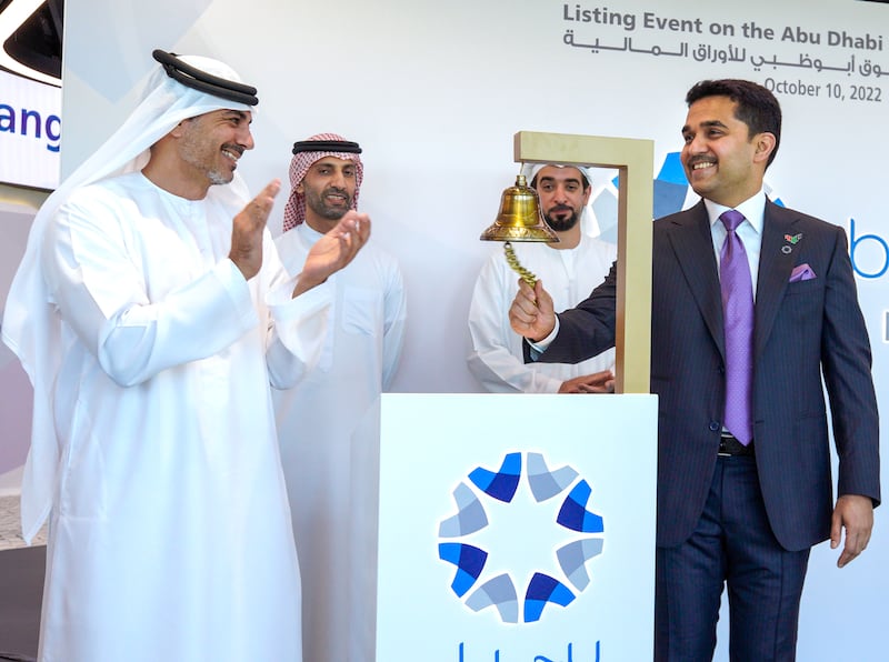 Burjeel Holdings chairman Dr Shamsheer Vayalil, right, rings the bell as ADX chairman Hisham Malak, ADX chief executive Saeed Al Dhaheri and Burjeel Holdings director Omran Al Khoori look on. Victor Besa / The National