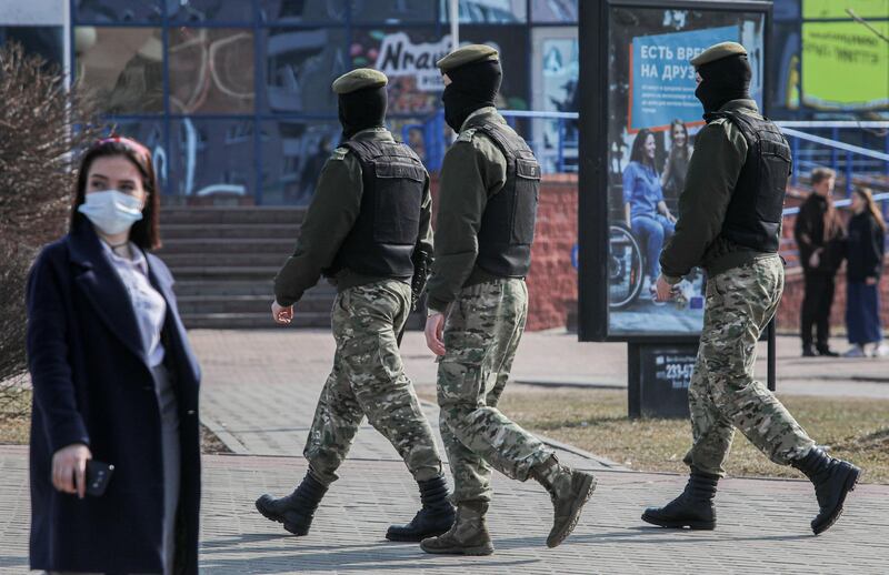 Belarusian law enforcement officers patrol a street, as opposition supporters gather for a rally against President Alexander Lukashenko in Minsk, Belarus March 27, 2021. BelaPAN via REUTERS ATTENTION EDITORS - THIS IMAGE WAS PROVIDED BY A THIRD PARTY. MANDATORY CREDIT.