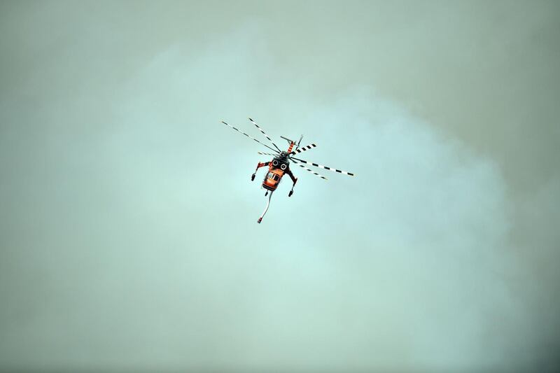 A helicopter flies during an operation to douse bushfires in Penrose, in Australia's New South Wales state. AFP