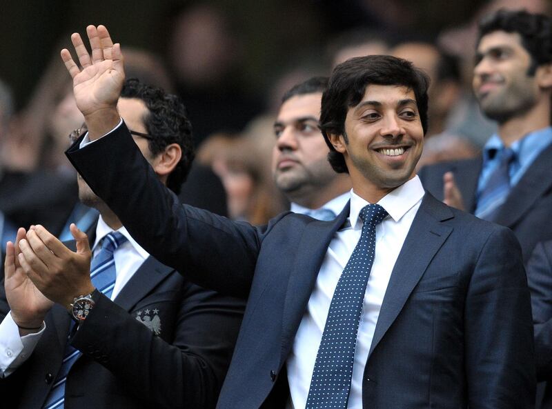 (FILES) In this file photo taken on August 23, 2010 Manchester city owner Sheikh Mansour bin Zayed Al Nahyan waves during the English Premier League football match against Liverpool at The City of Manchester stadium, Manchester, north-west England. - Just 10 years after he bought struggling Manchester City, Sheikh Mansour has the satisfaction of knowing his billions have transformed the club from a national punchline to the kings of English football. (Photo by Andrew YATES / AFP)