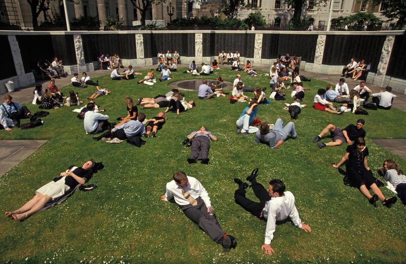 Summers have been getting warmed in London. City office workers stretch out over the grass during a hot summer lunchtime in Trinity Square in the City of London, July 1993, in London. Getty Images