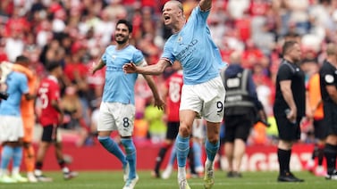 Manchester City's Ilkay Gundogan, left, and Erling Haaland celebrate Manchester City's win against Manchester United at Wembley Stadium. PA