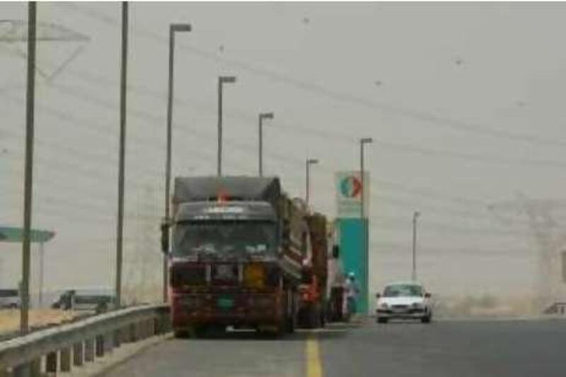 Dubai, 15th July 2008.  Lorries parked along the hard shoulder of Emirates Road.  (Jeffrey E. Biteng / The National)  Editors Note; Spent two hours looking for lorries parked illegally at residential areas, but to no avail. *** Local Caption ***  JB0513-Lorries.jpgJB0513-Lorries.jpg