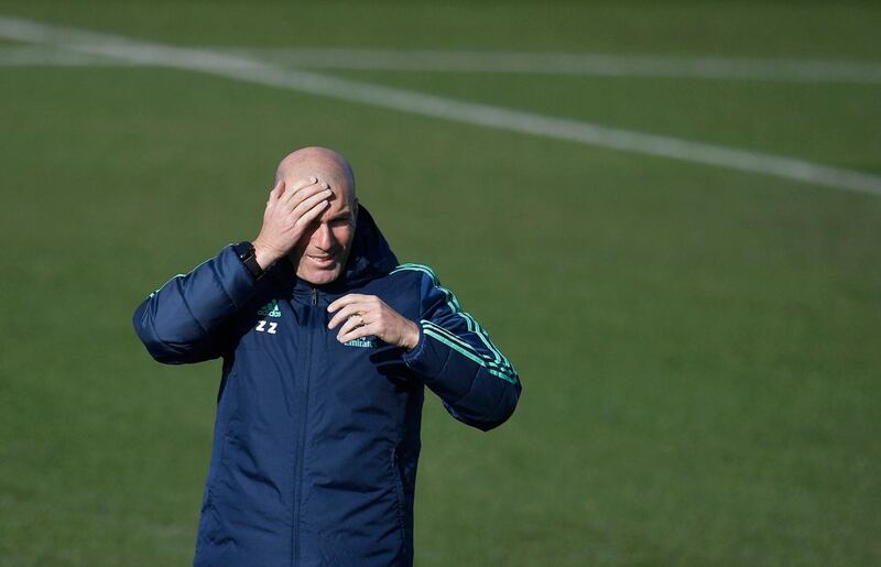 Real Madrid's coach Zinedine Zidane attends a training session at the Real Madrid City sports facilities in Madrid on the eve of their UEFA Champions League match against Paris Saint-Germain. AFP