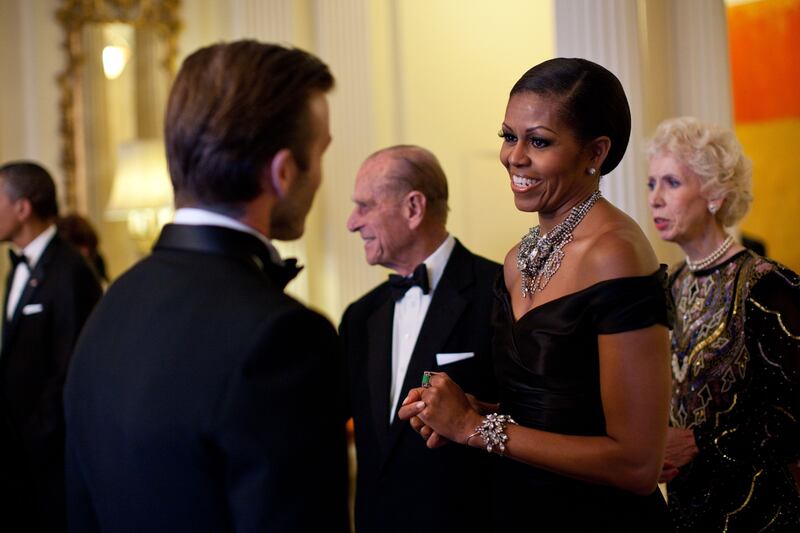 Ms Obama greets football star David Beckham at a dinner in honour of the queen at Winfield House in London, on May 25, 2011. Photo: US National Archives