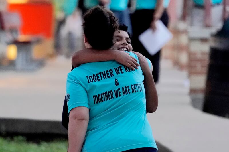 A teacher hugs a pupil arriving at Uvalde Elementary for the first day of school. AP