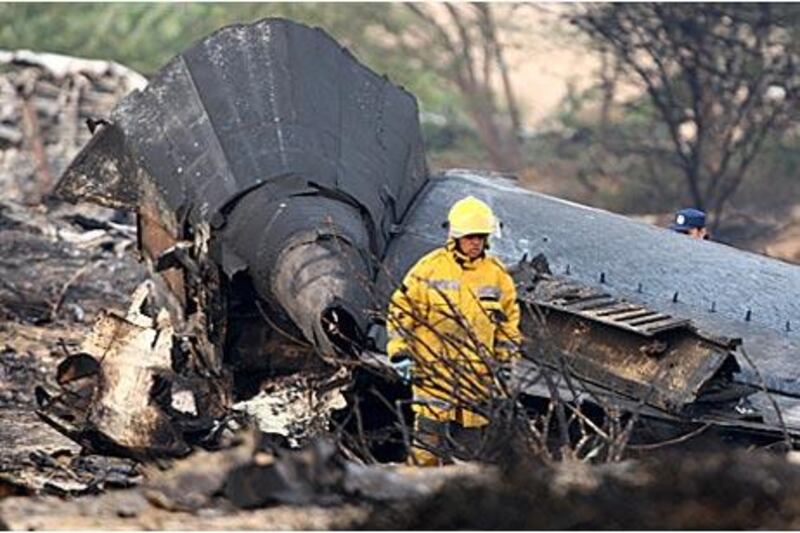 A fireman surveys the wreckage of a the cargo plane that crashed in Sharjah. The operator has since been banned from UAE airspace.